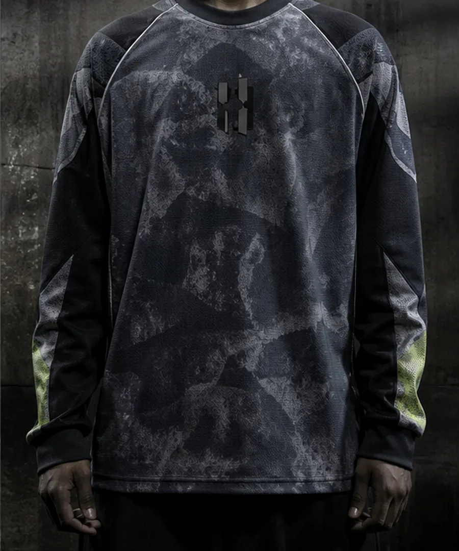 Temporary product image for Drop 03, a fictional dark long sleeve football top against concrete.